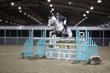 Alex Thompson takes the top spot in The Champagne Cave Winter Grades B & C Qualifier at The College Equestrian Centre, Keysoe